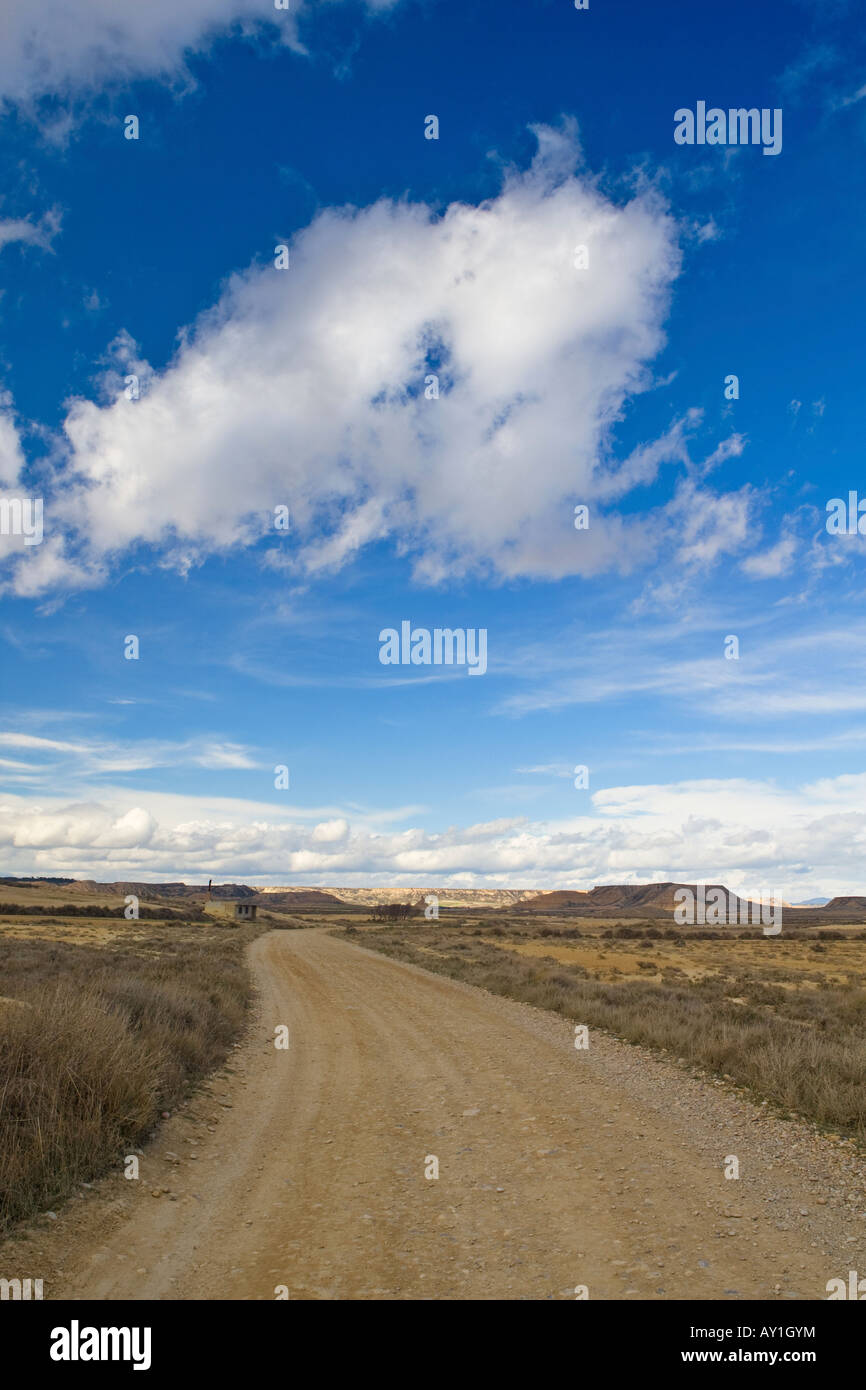 Lonely road to desert under cloudy sky Stock Photo - Alamy