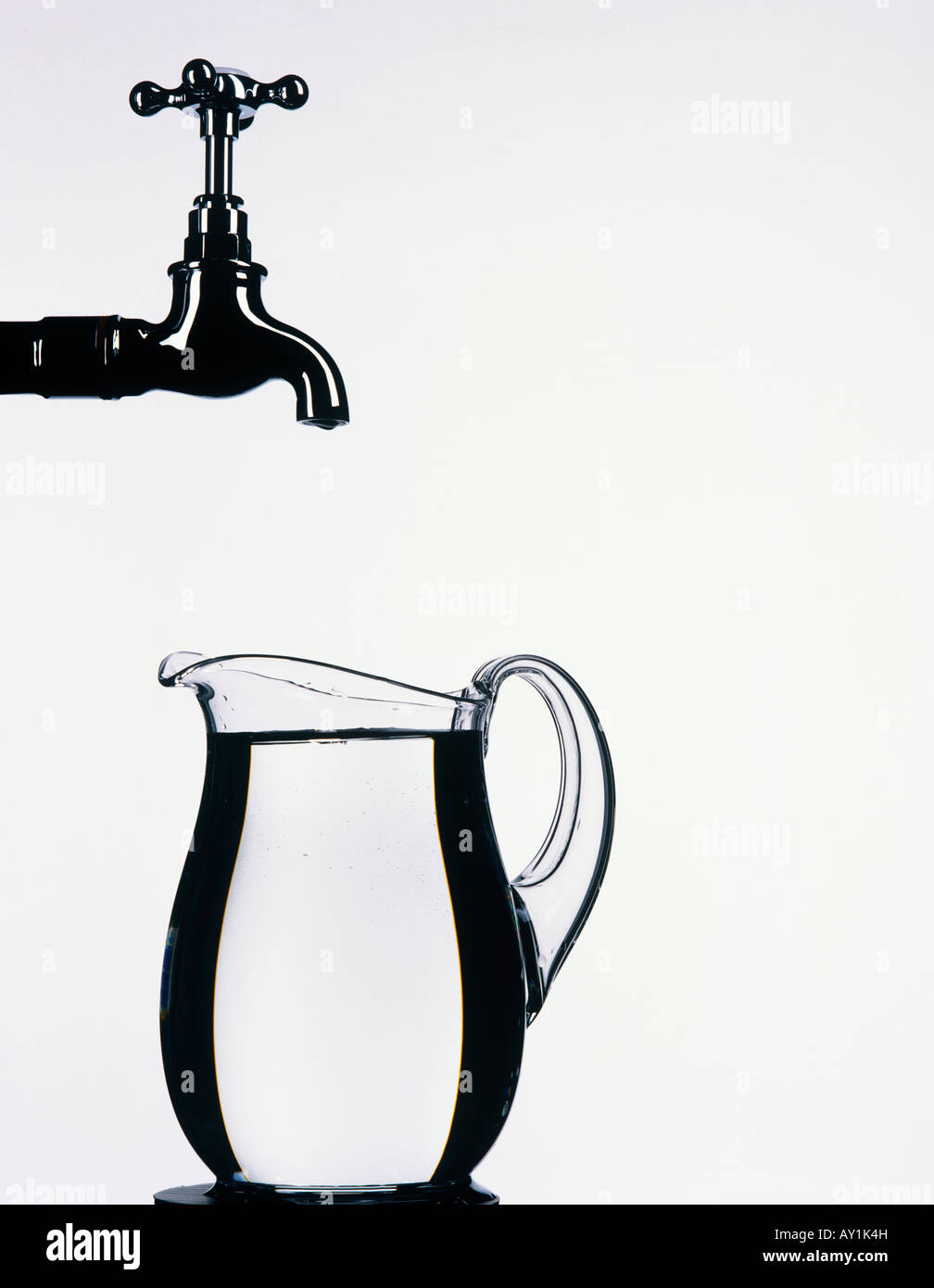 Tap with glass jug full of water Stock Photo Alamy