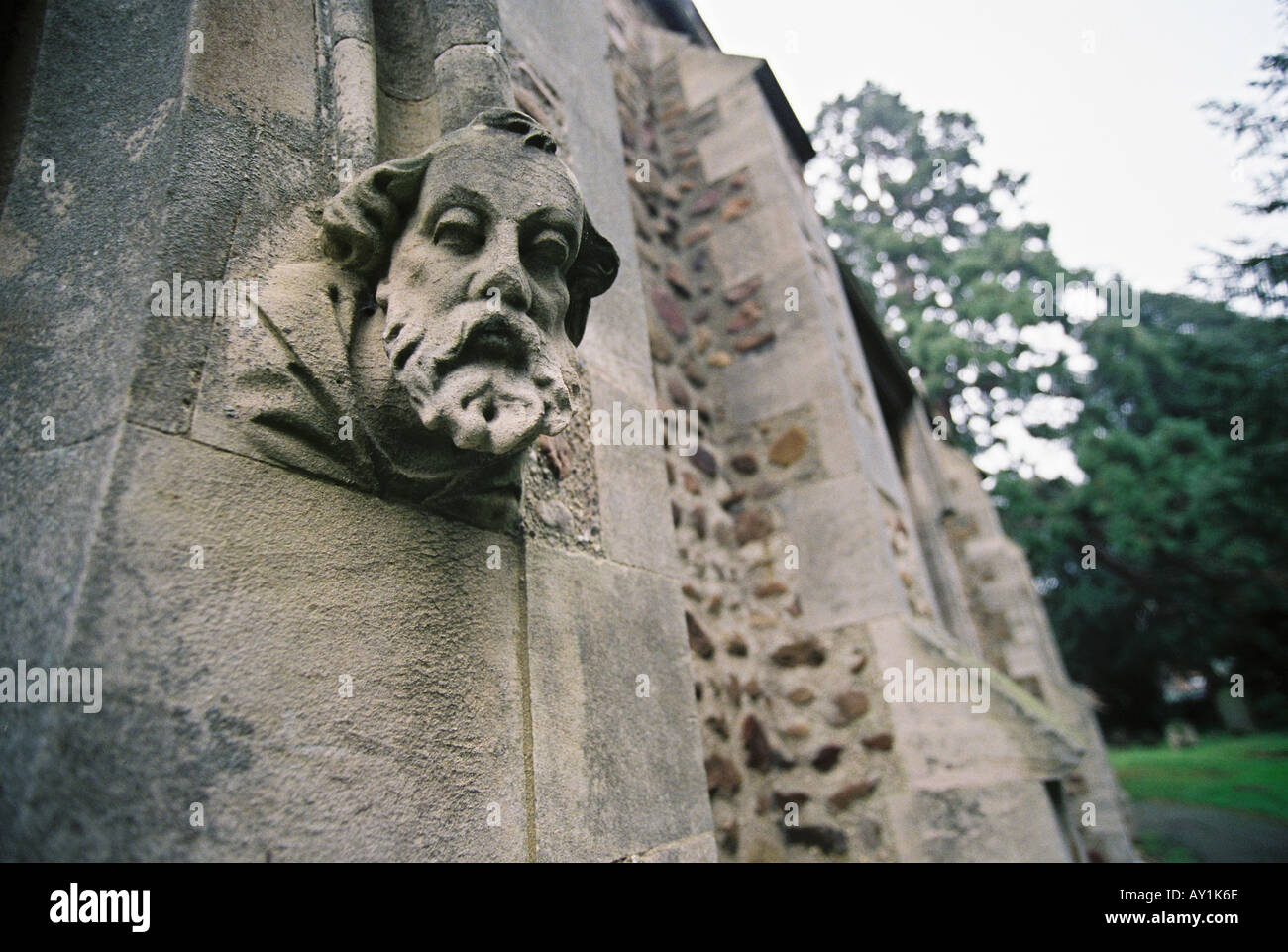 Gargoyle, Head, sculpture on exterior wall of church in Great Barford, Bedford, Bedfordshire, UK Stock Photo