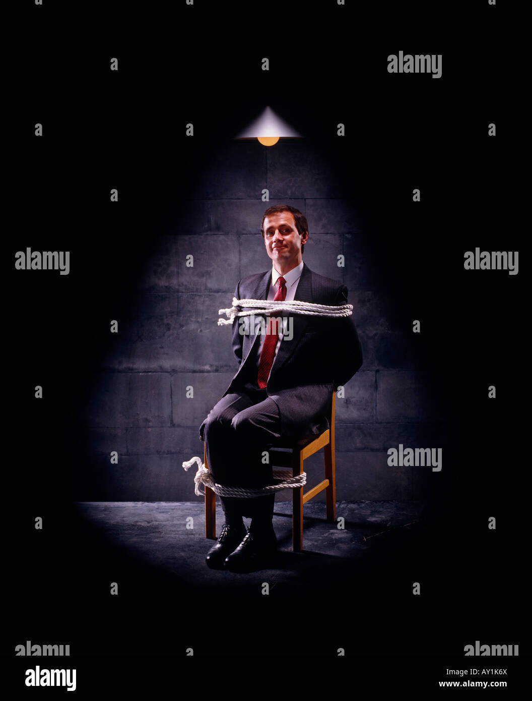 Tied Businessman/Executive under spotlight Stock Photo