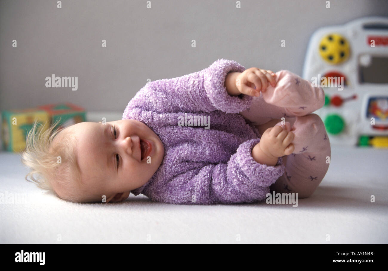 Baby playing with her feet Stock Photo - Alamy
