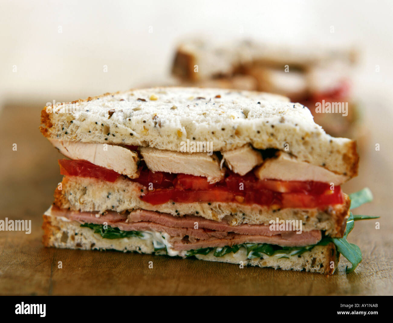 Sandwich of chicken tomato ham and salad on seeded bread Stock Photo