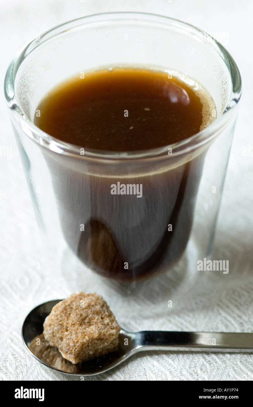 Bodum coffee glass with espresso coffee sugar lump and spoon on linen ...