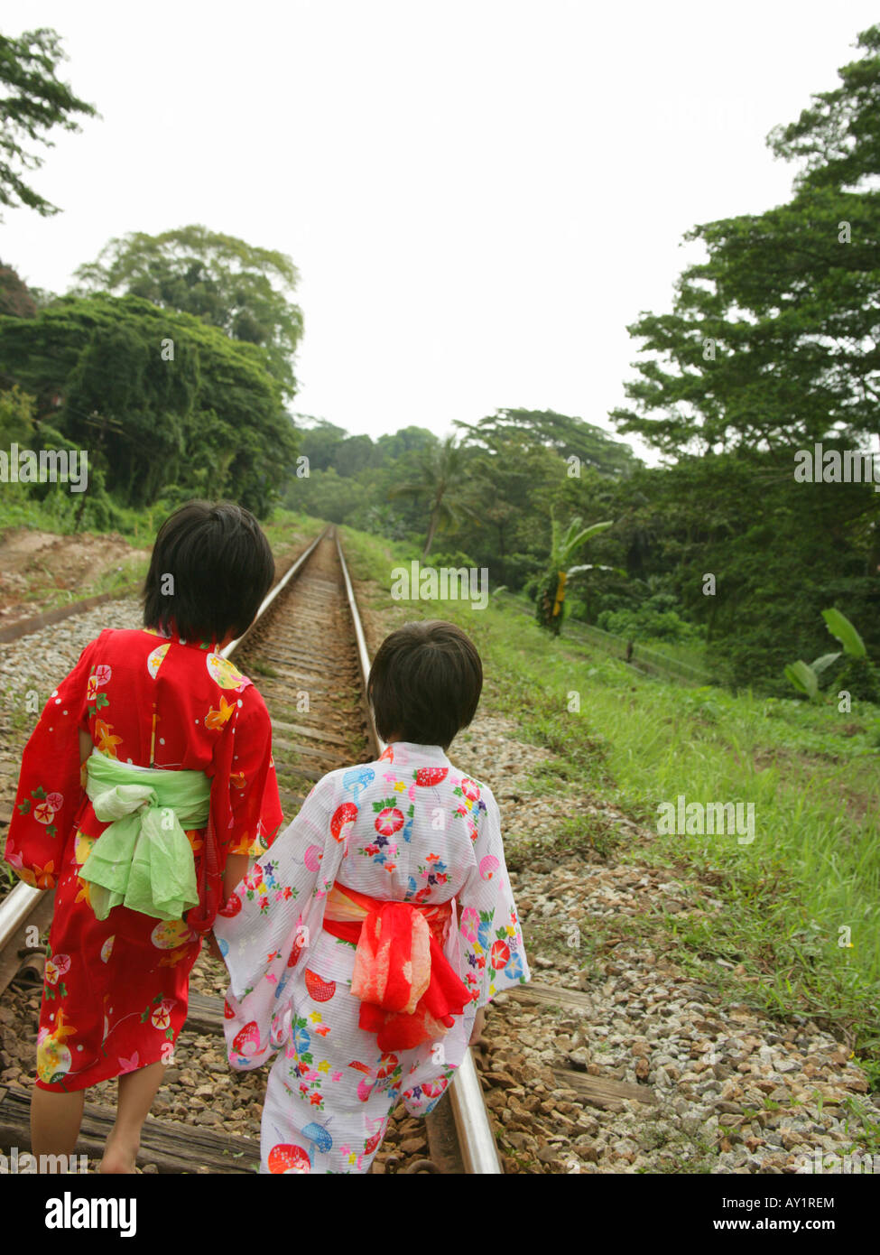 Rear view of two girls walking on railroad tracks Stock Photo Alamy
