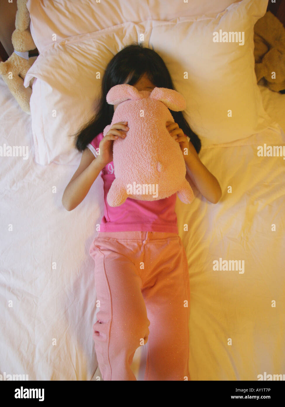 Girl lying on bed with toy hi-res stock photography and images - Alamy