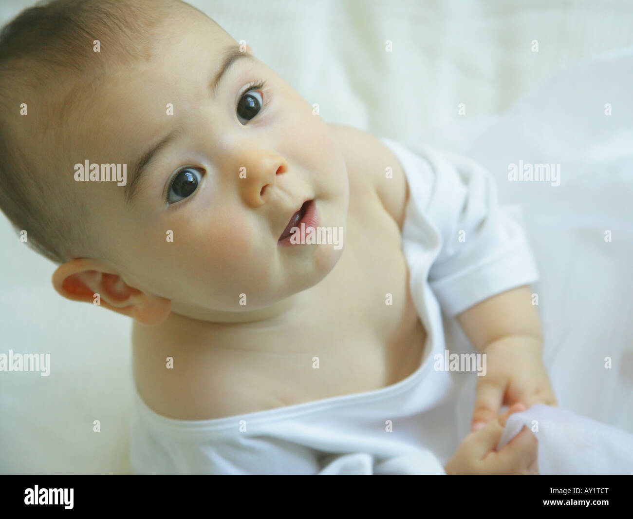 Close-up of a baby girl looking up Stock Photo - Alamy