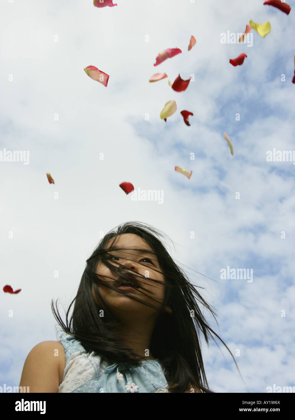 Low angle view of a girl throwing flower petals in the air Stock Photo Alamy