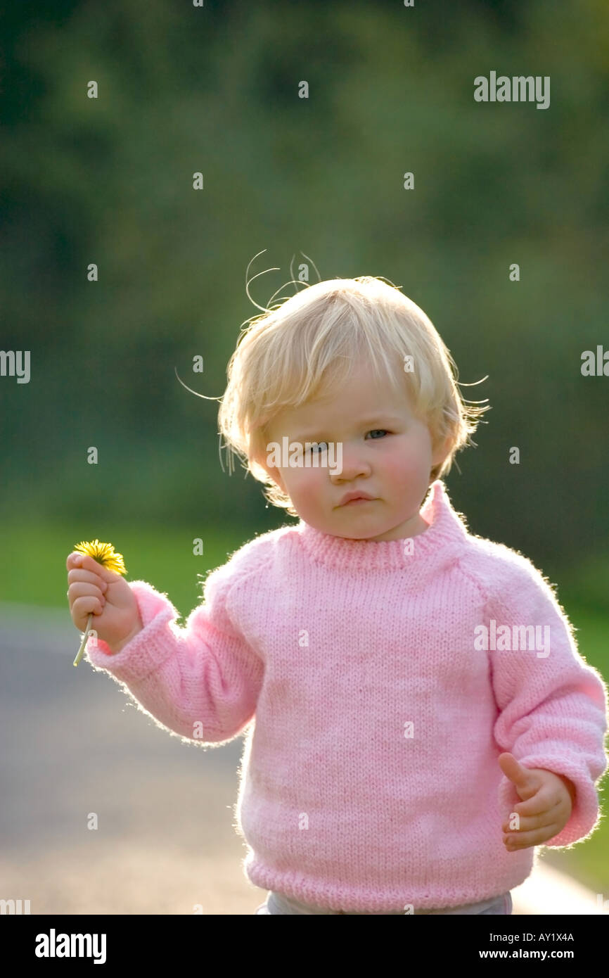Little girl carrying daffodil Stock Photo Alamy