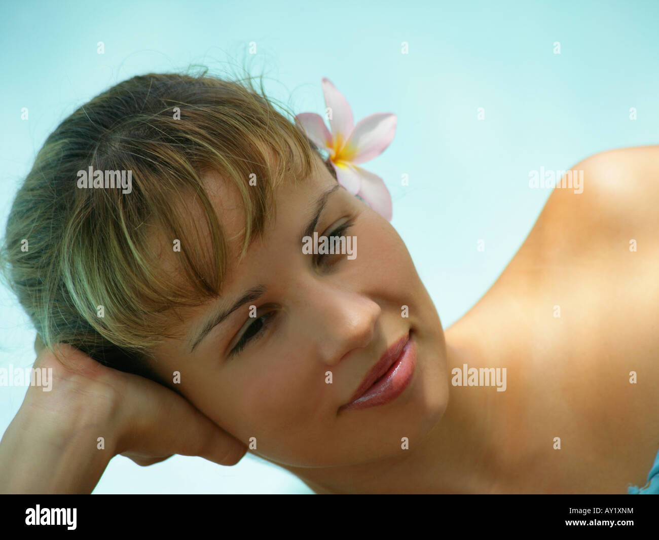Close-up of a young woman resting her head on her hand Stock Photo - Alamy
