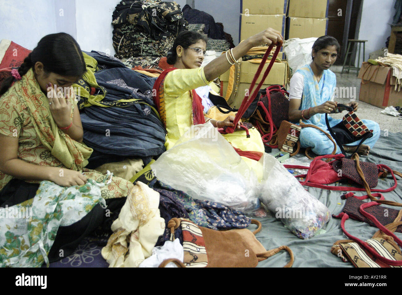 Women work at stitching, sorting and folding garments in a clothing factory in Jaipur, Rajasthan. Stock Photo