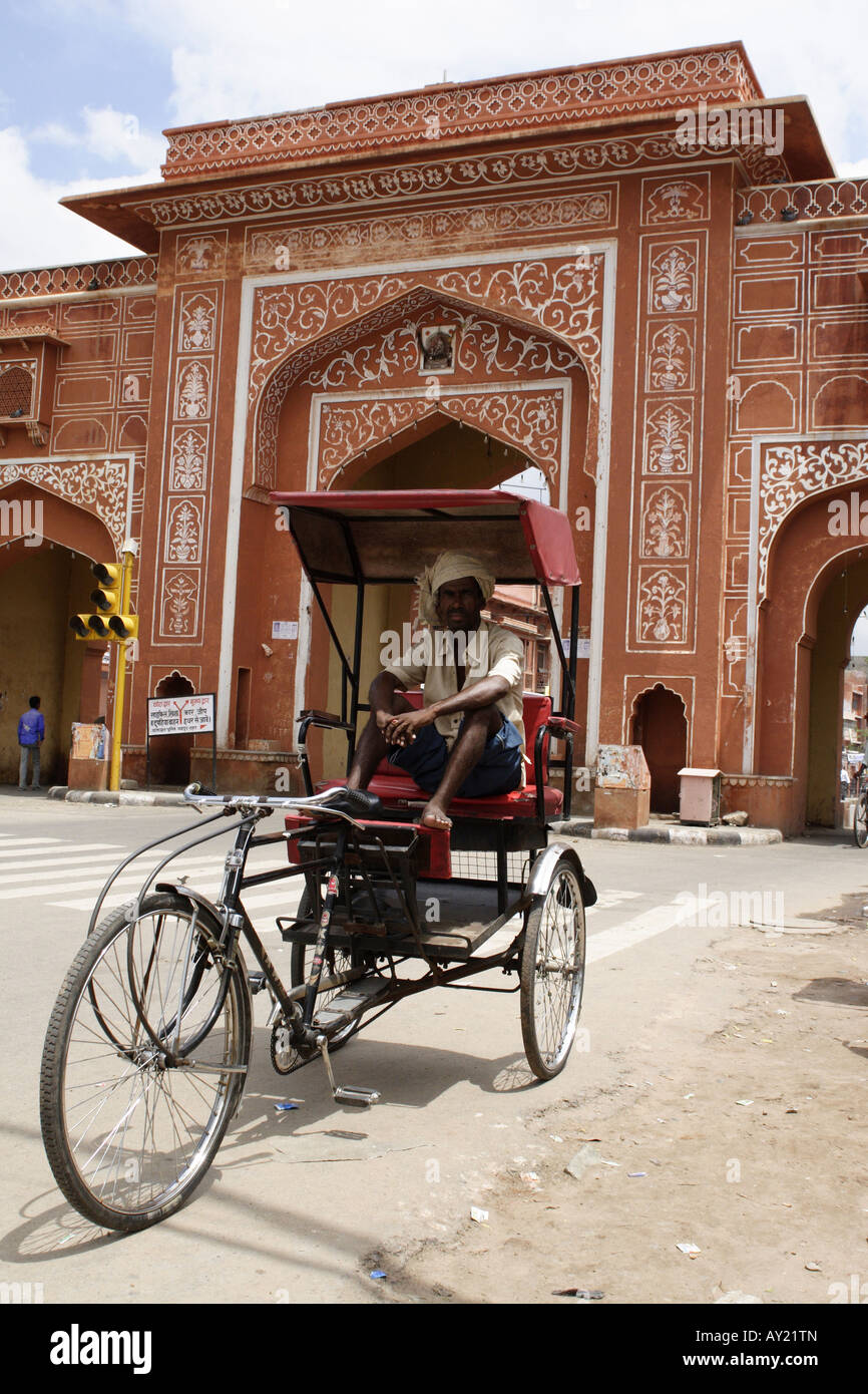 A bicycle rickshaw driver sits under the shade of the canopy of his vehicle in Jaipur, Rajasthan. Stock Photo