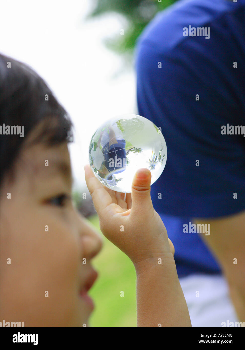 Two people holding up globe hi-res stock photography and images - Alamy