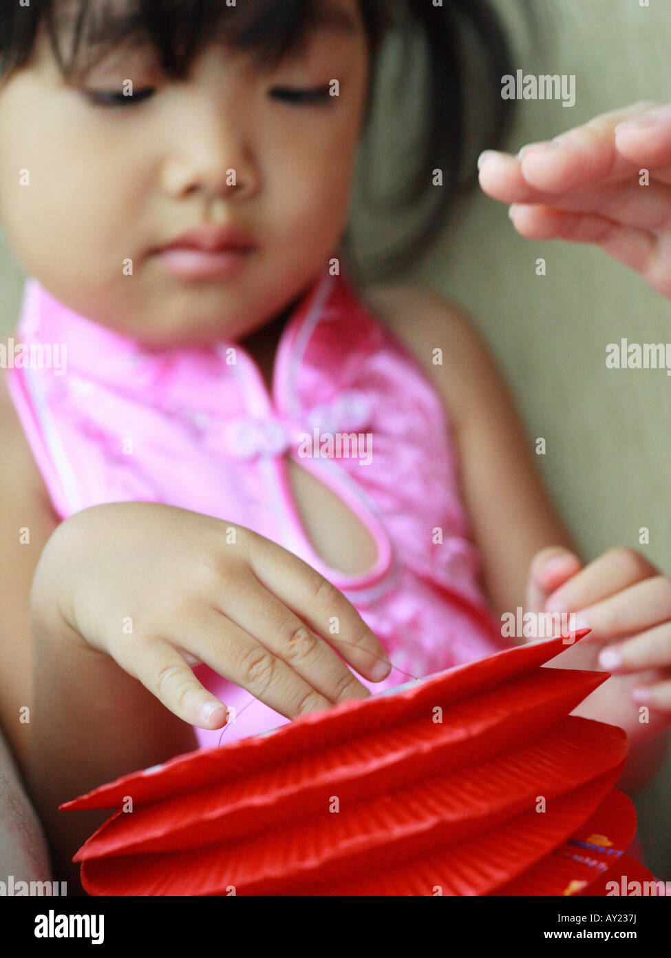 Close-up of a girl holding a Chinese lantern Stock Photo