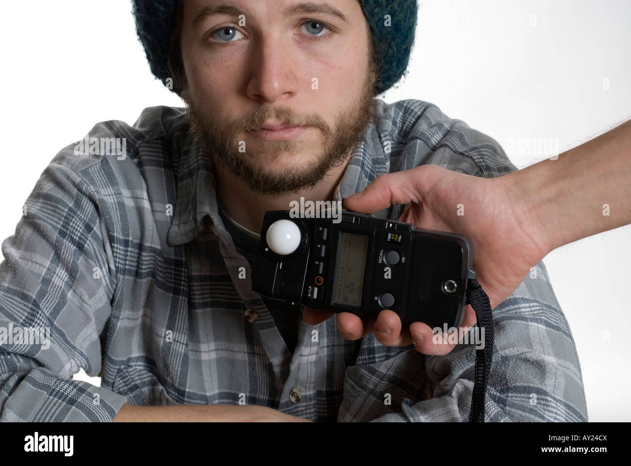 Young man being measured with photography light meter Stock Photo Alamy