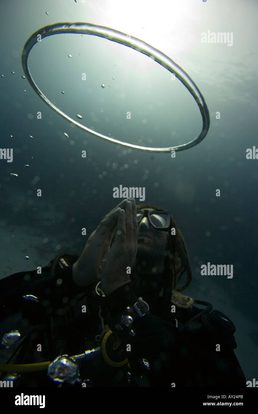 Bubble rings made by diver float to the surface Bubbles are made