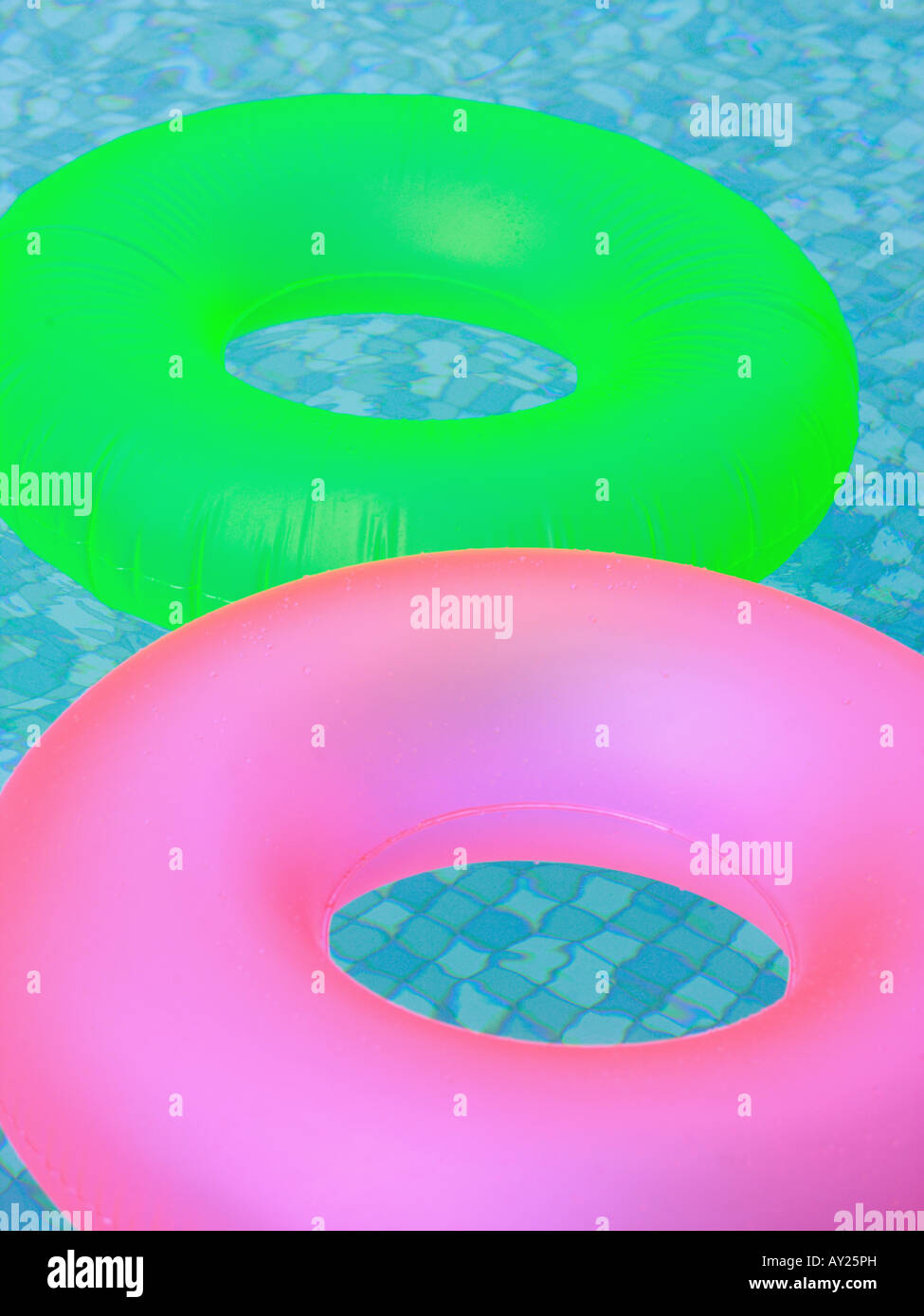 High angle view of two inflatable rings floating in a swimming pool ...