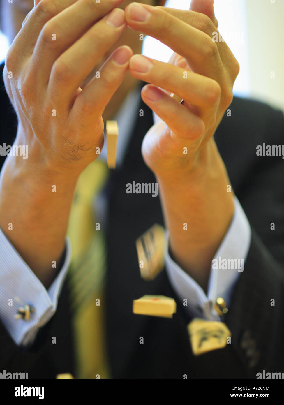 Mid section view of a businessman throwing Japanese chess pieces Stock Photo
