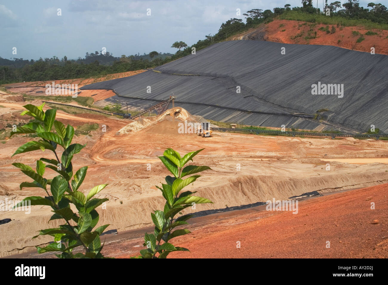 Surface gold mining showing dump heap leach pad, Ghana Stock Photo