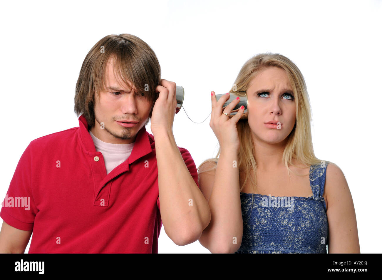 Young couple using a tin can phone and unable to communicate Stock Photo