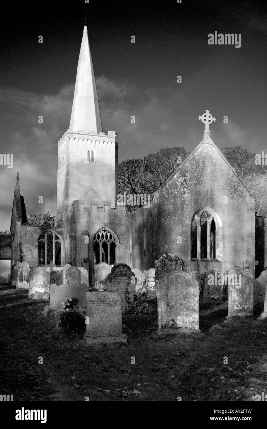 Atmospheric Infrared Style monochrome image of a graveyard and derelict church with glassless windows and no roof Stock Photo