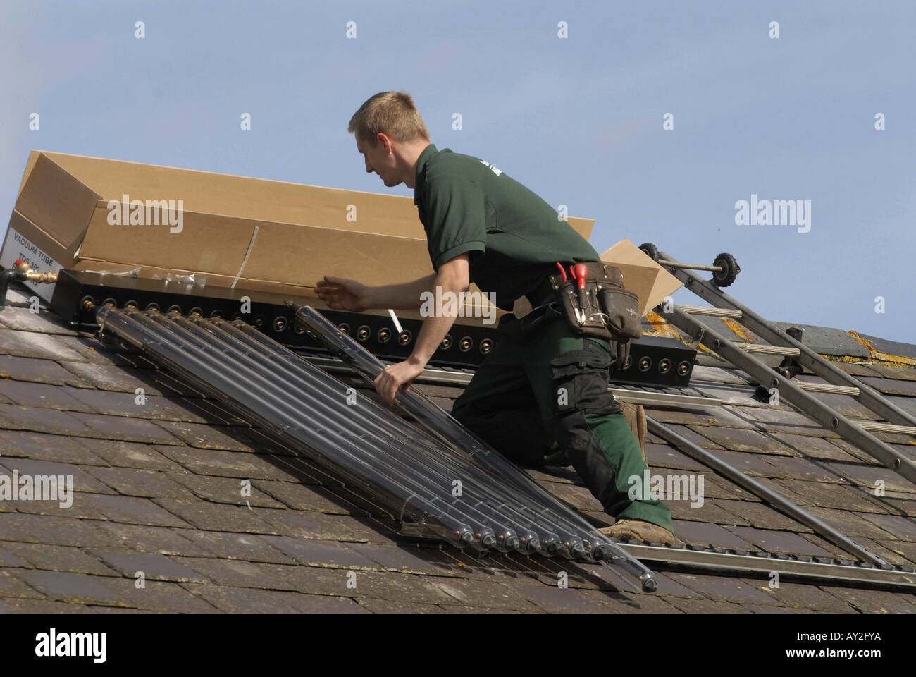 Solar Water Heating Solar Water Heating system being installed on the roof of a house in Southern England Stock Photo