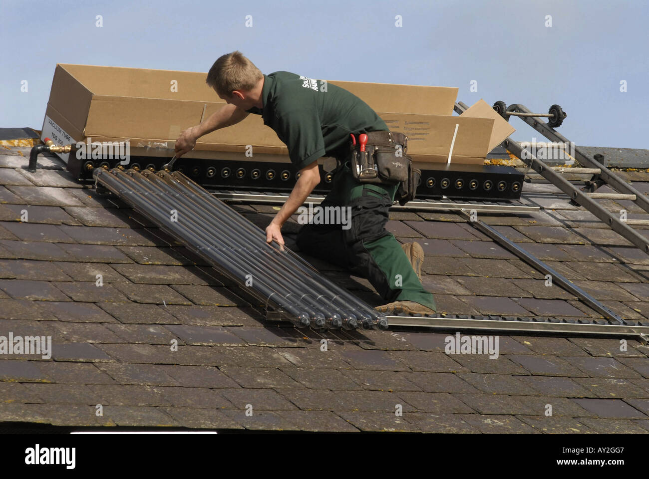 Solar Water Heating Solar Water Heating system being installed on the roof of a house in Southern England Stock Photo