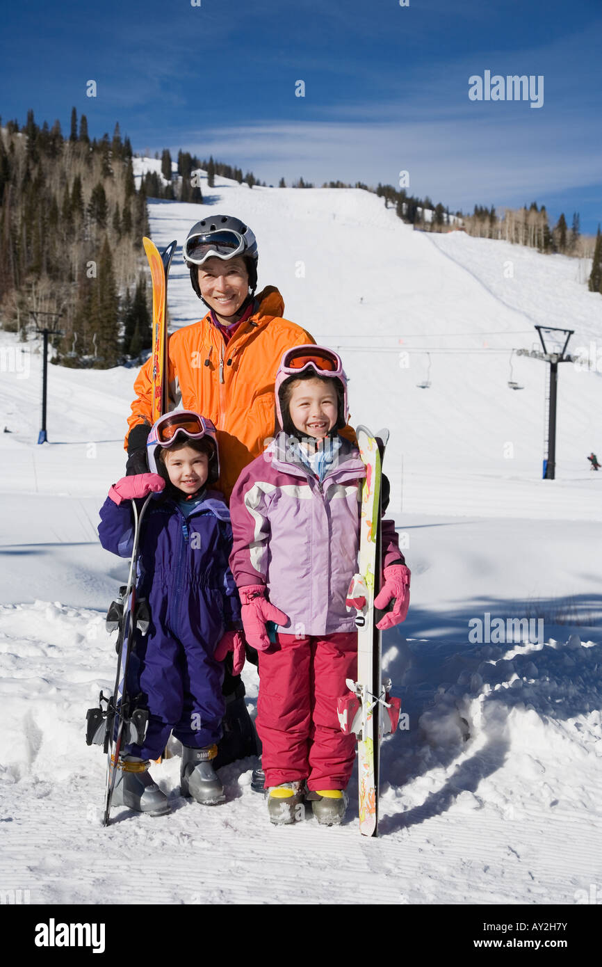 Asian mother and daughters in ski gear Stock Photo