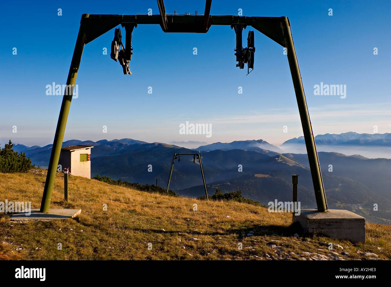 Panorama with old ski lift mountain meadow and smoth blue sky Stock Photo
