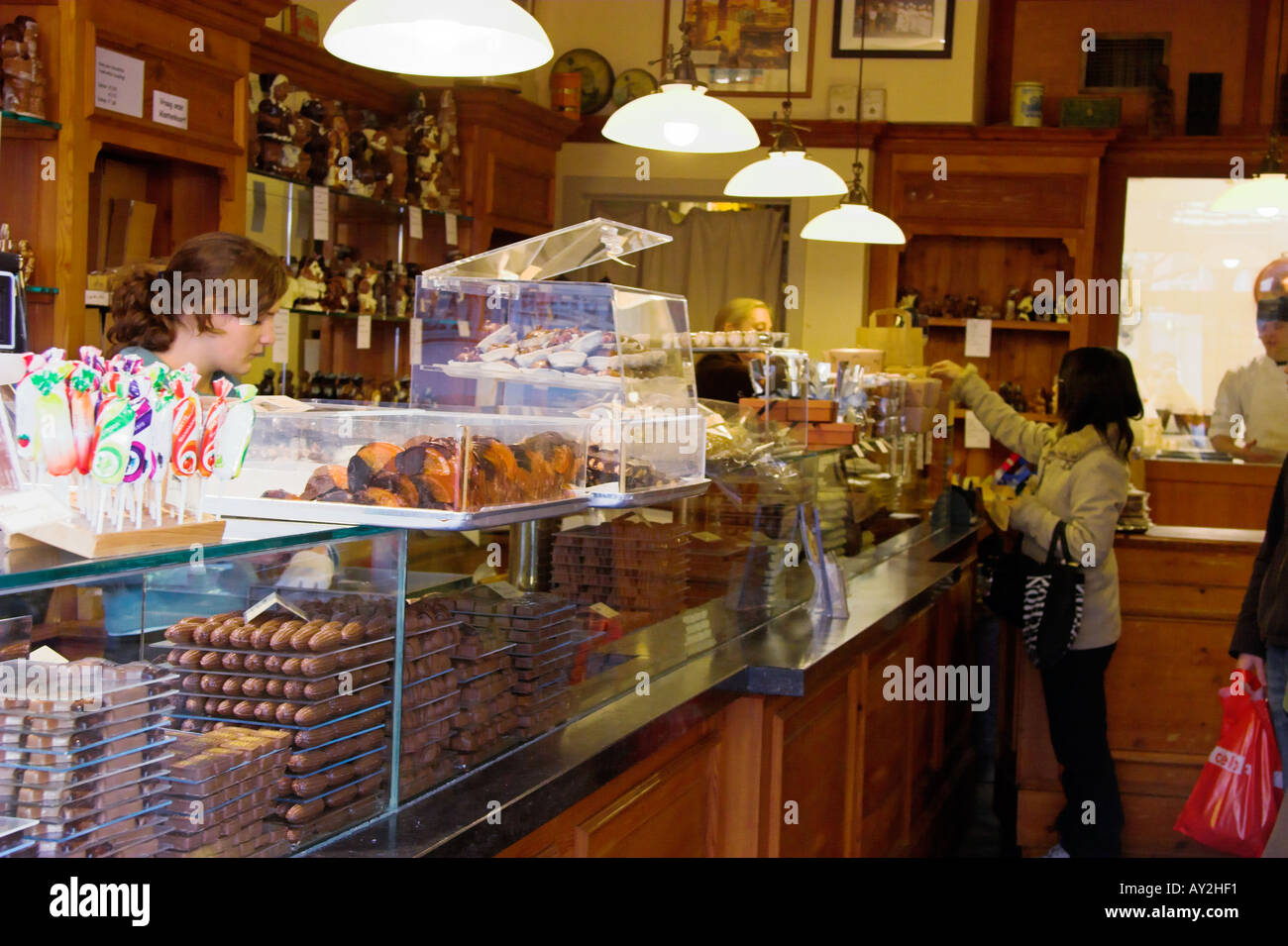 Japanese tourist in The Chocolate Line chocolate shop Steenplein Brugge Belgium Stock Photo
