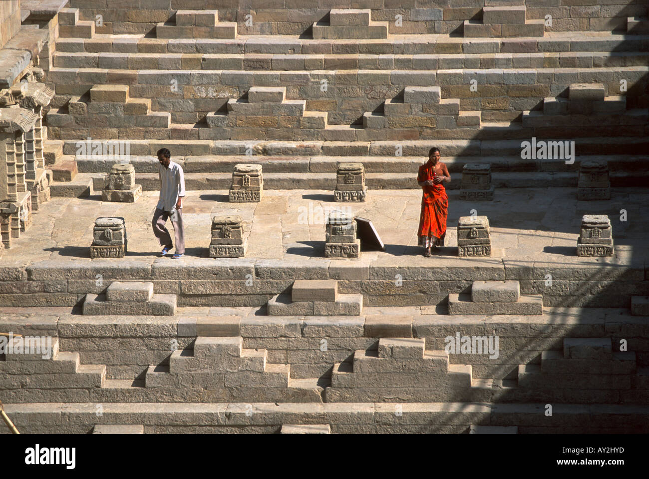 Woman in red on the steps of the Patan step well, called the Rani ki vav, Gujarat, India. Built about 1050 A.D. Stock Photo