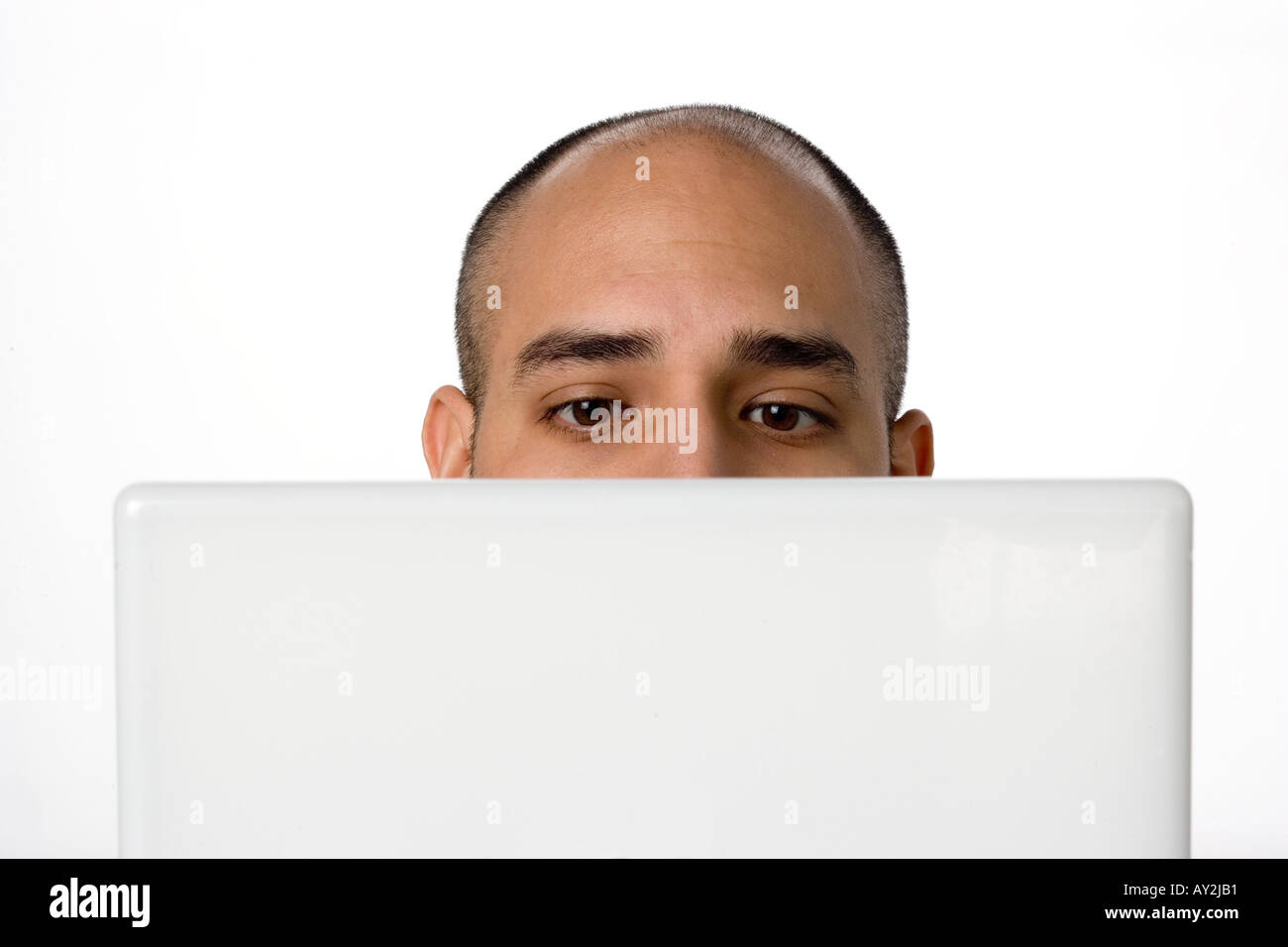 Portrait Latino man lookiing at laptop computer Stock Photo