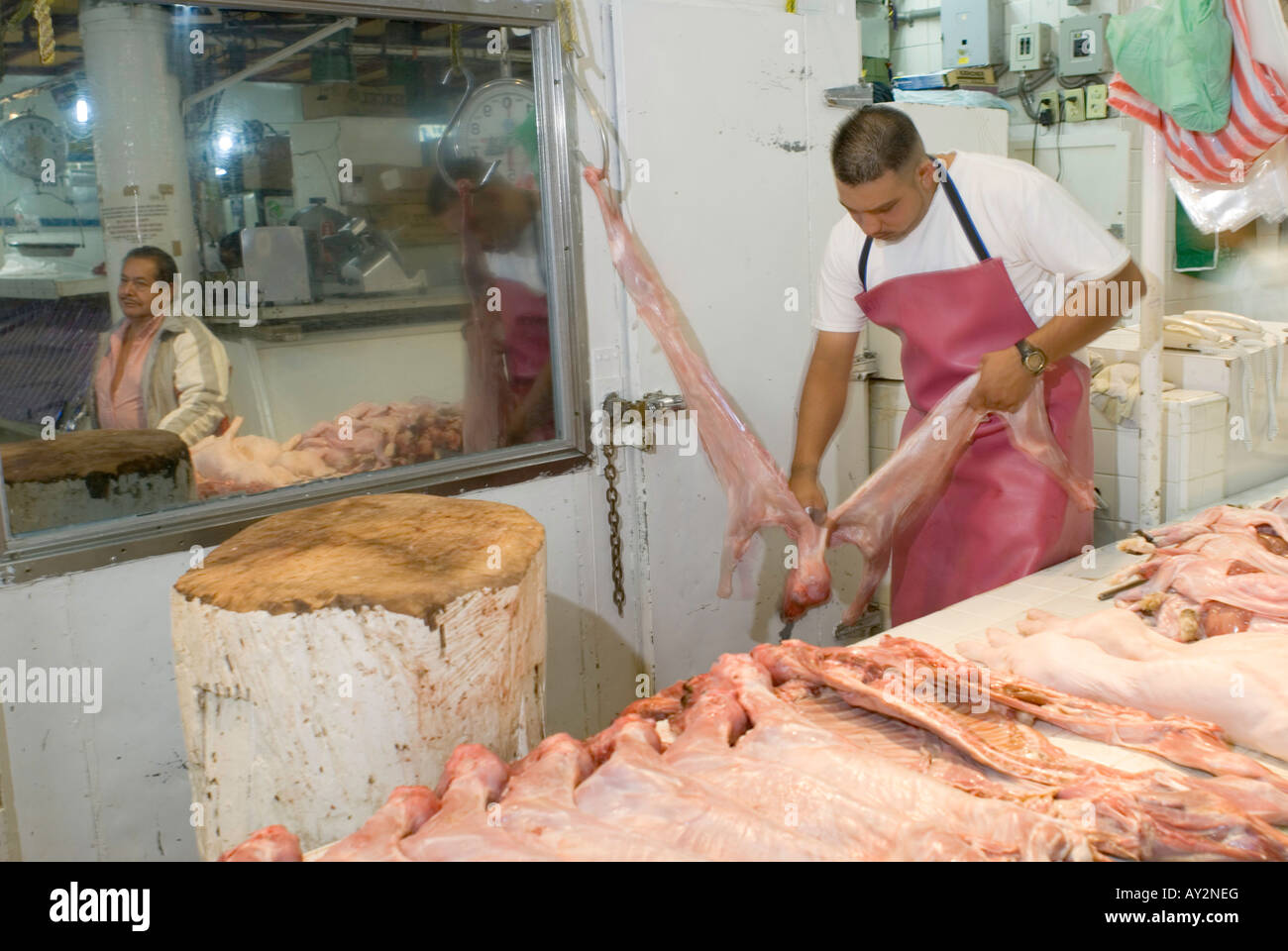 Skinning and sectioning baby goat, cabrito, at the San Jan market in Mexico City center. Stock Photo