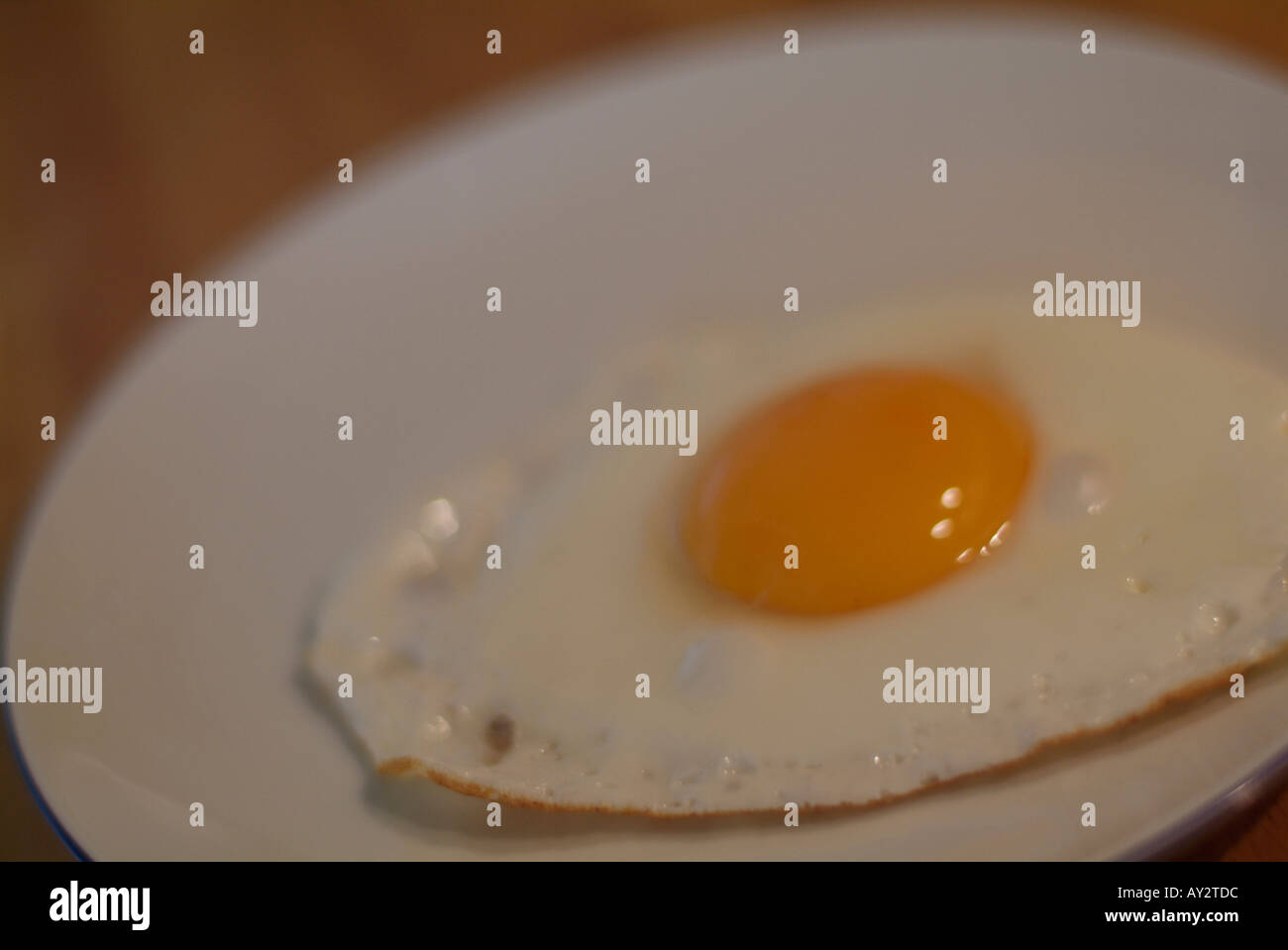 One single fried egg on table Stock Photo
