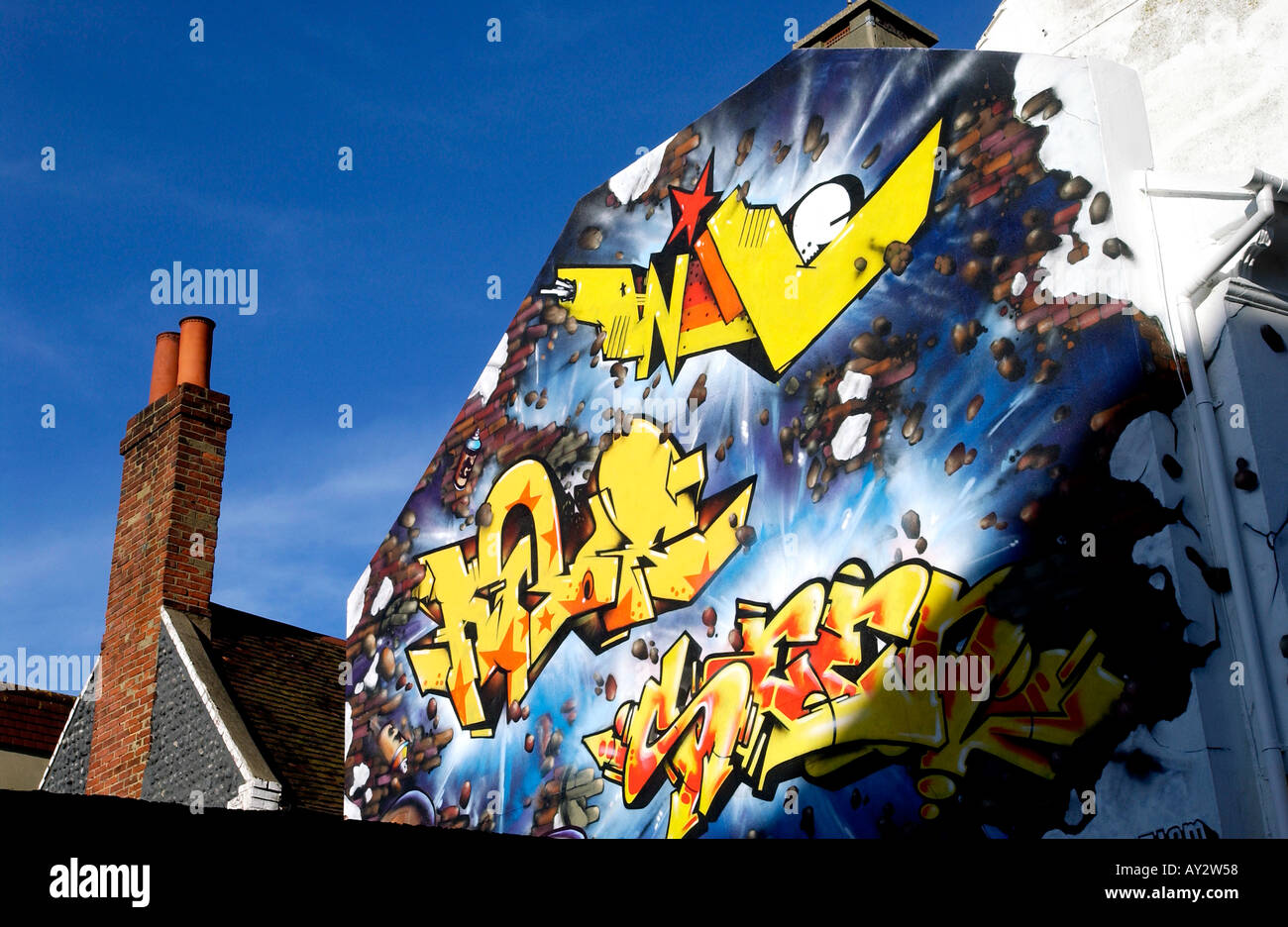 An end of terrace shop in cental Brighton decorated with vibrant grafitti Stock Photo