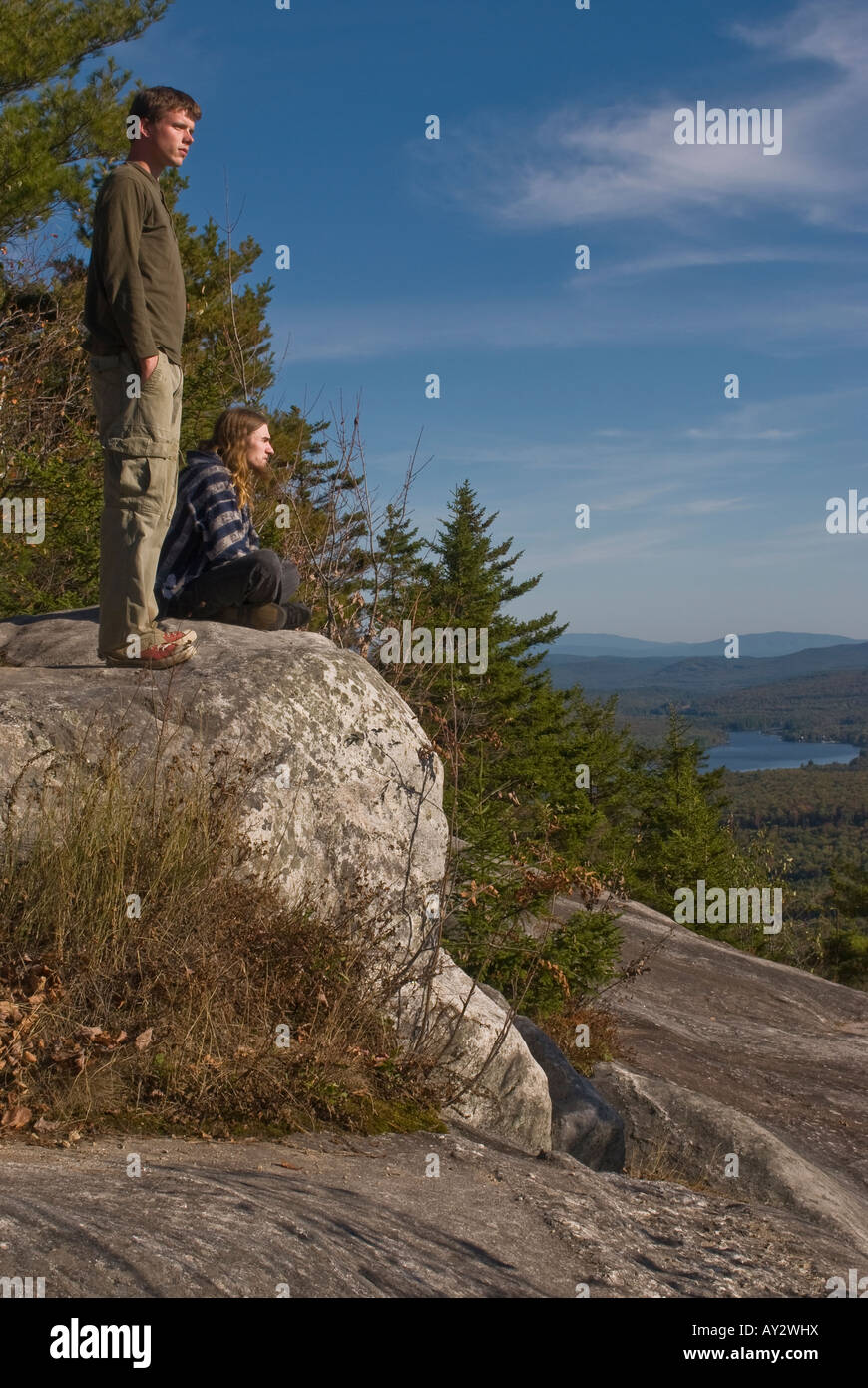 Two men in their 20's on a rock ledge at the top of Owl's Head Mountain