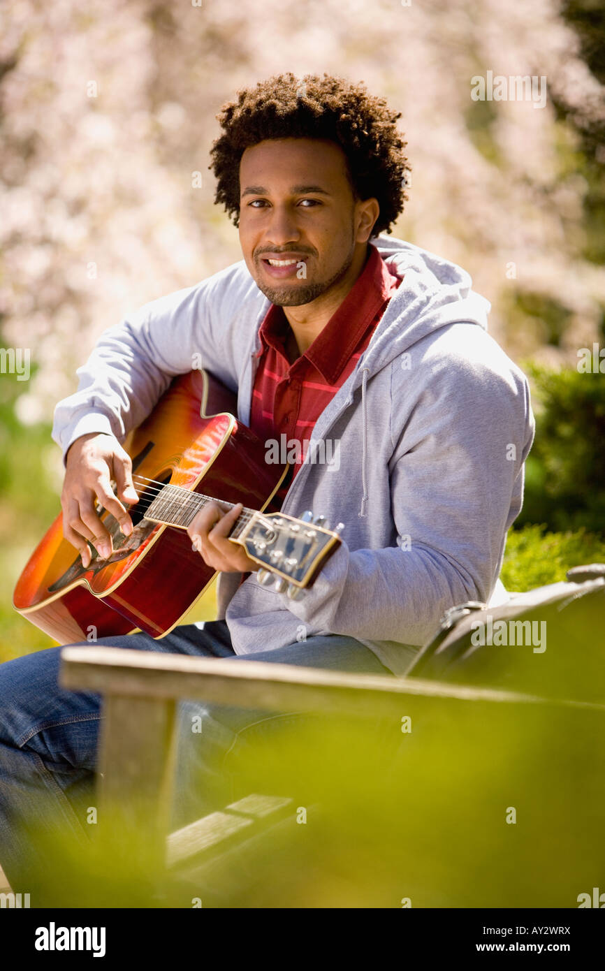 African American man playing acoustic guitar Stock Photo - Alamy