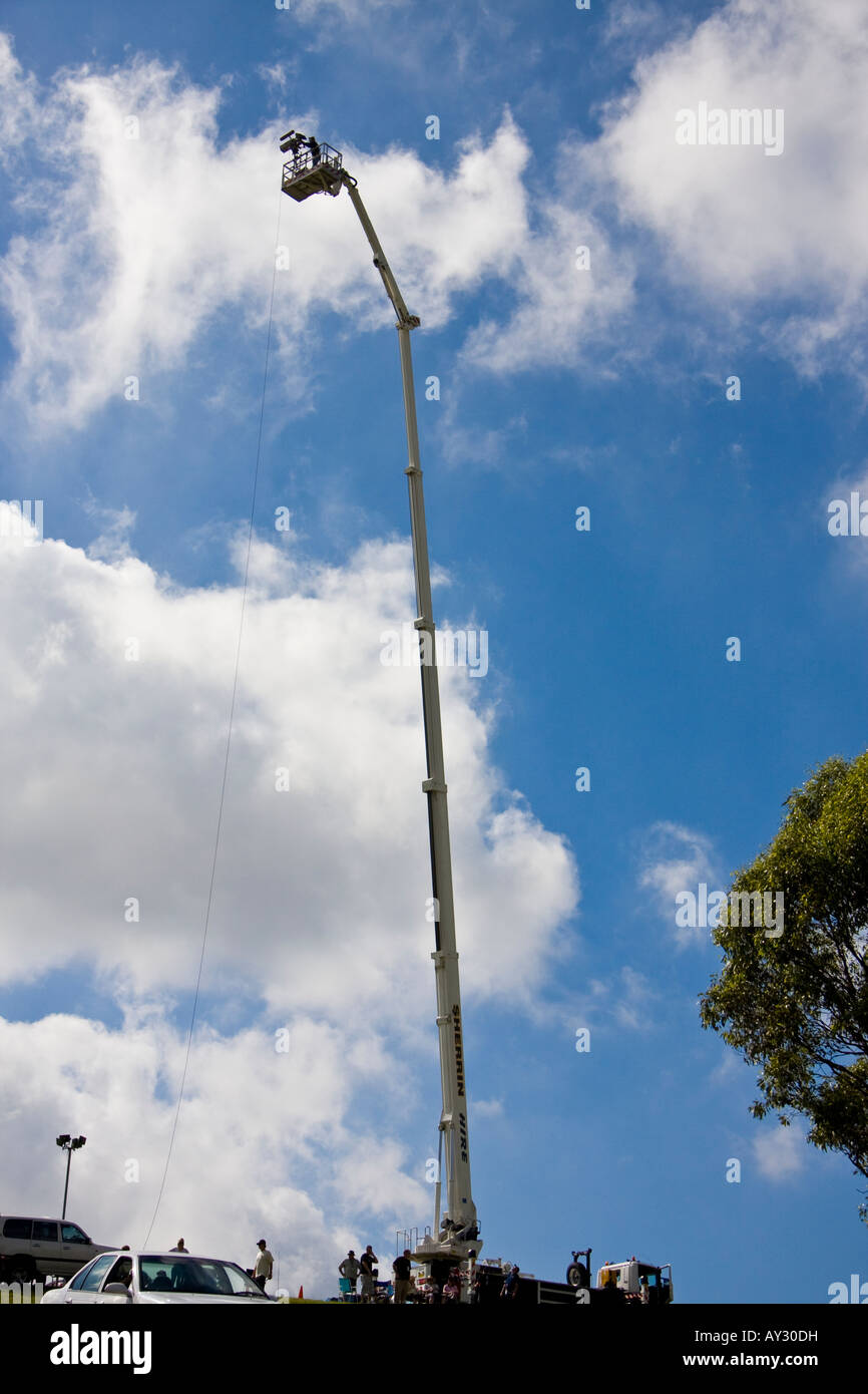 A TV cameraman riding a telescopic work platform during an outside broadcast Stock Photo
