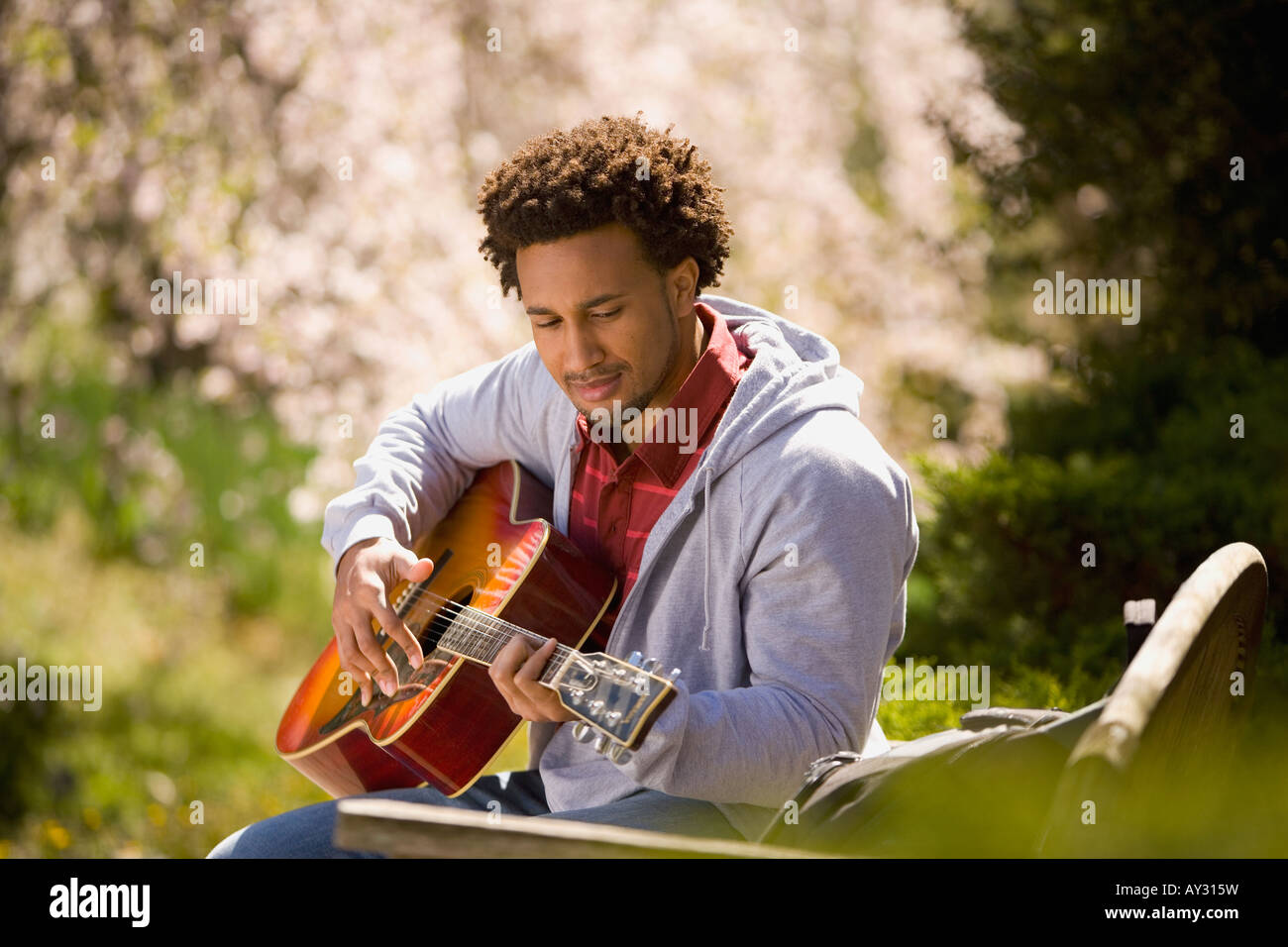 African American man playing acoustic guitar Stock Photo - Alamy