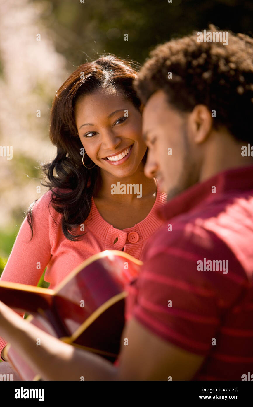 African American man playing guitar for girlfriend Stock Photo - Alamy