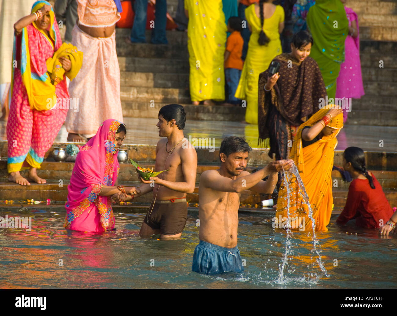 People bathing and making puja on Ganga Ghat in Haridwar in India Stock Photo
