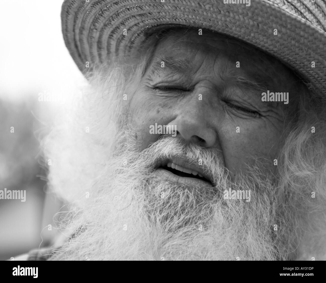 Old man long white hair and beard. Hat eyes closed expressive close up black & white thoughtful Stock Photo