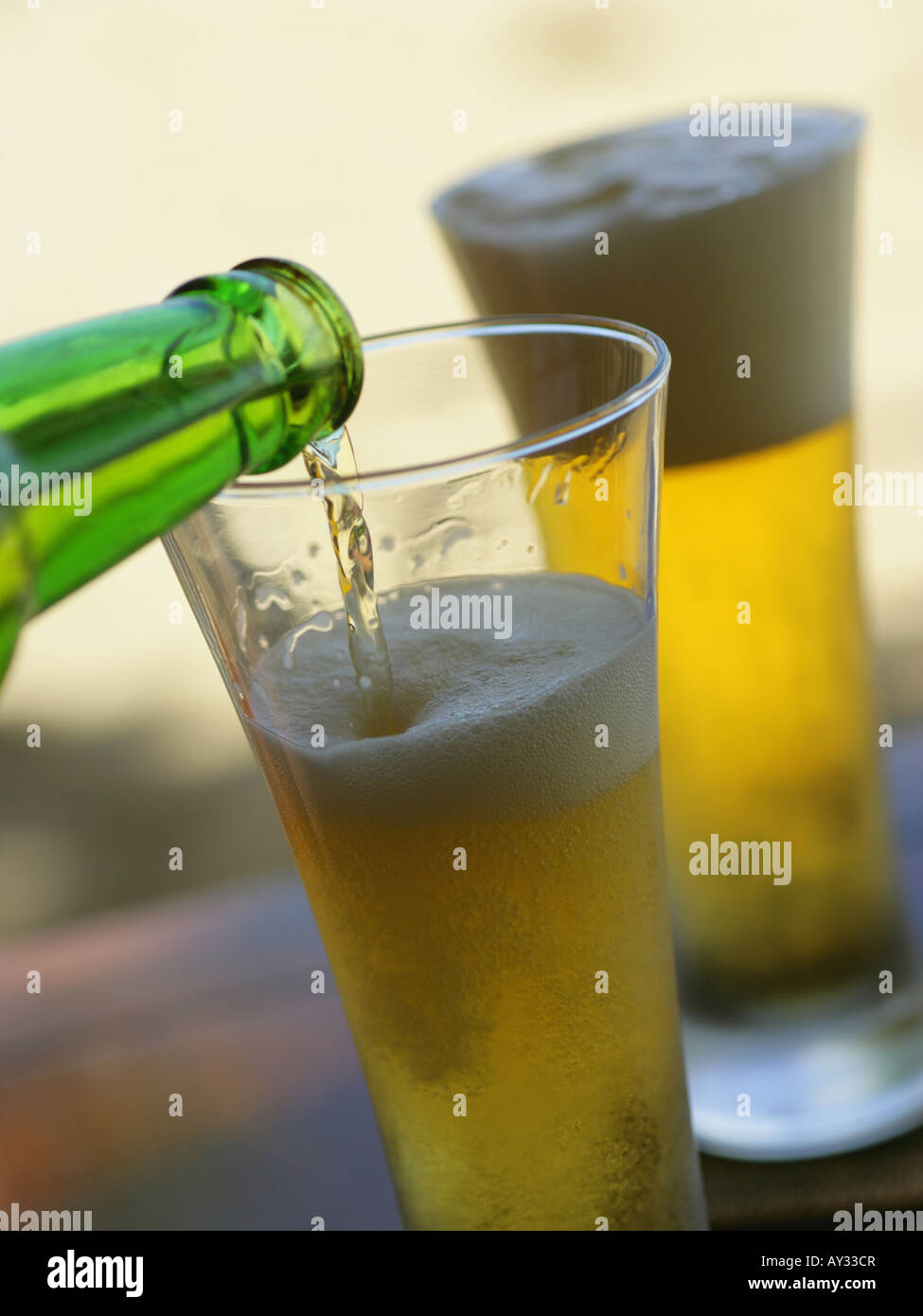 Beer being poured from a bottle into a beer glass Stock Photo Alamy
