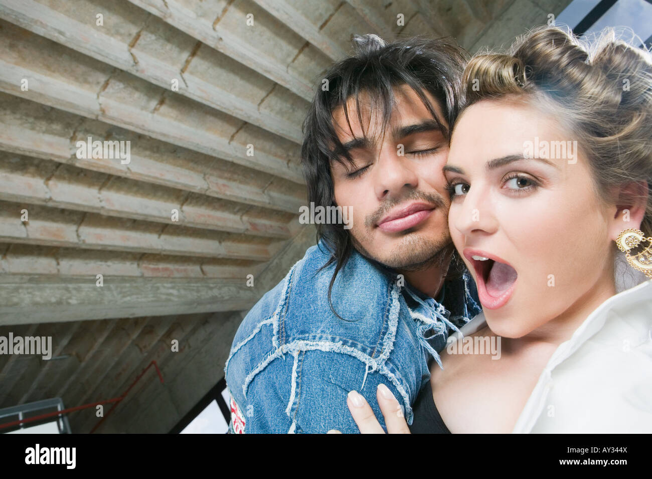 Hispanic couple hugging Stock Photo - Alamy