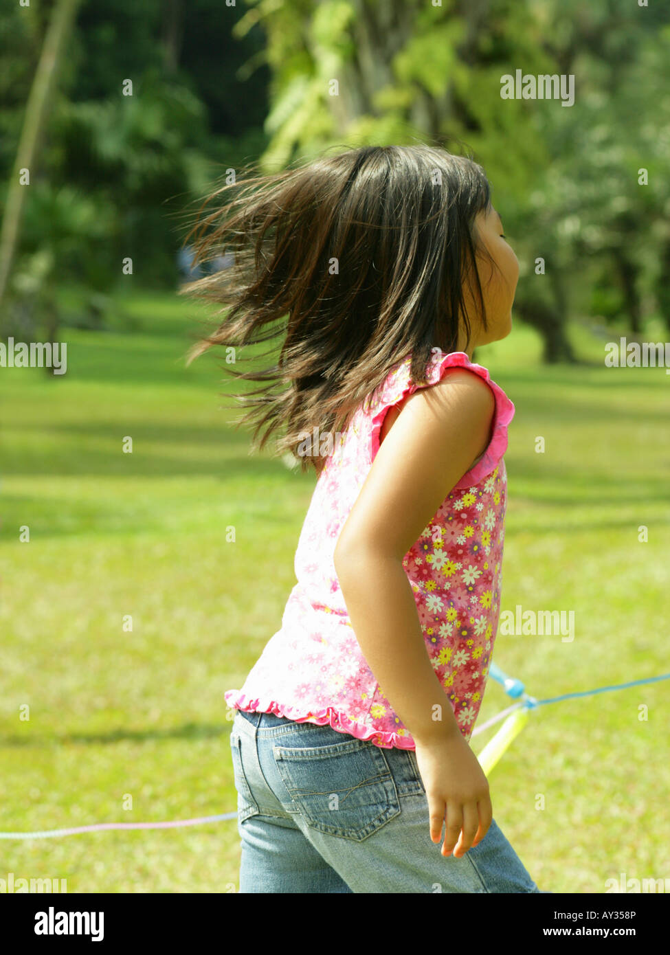 Side profile of a girl playing jump rope Stock Photo - Alamy