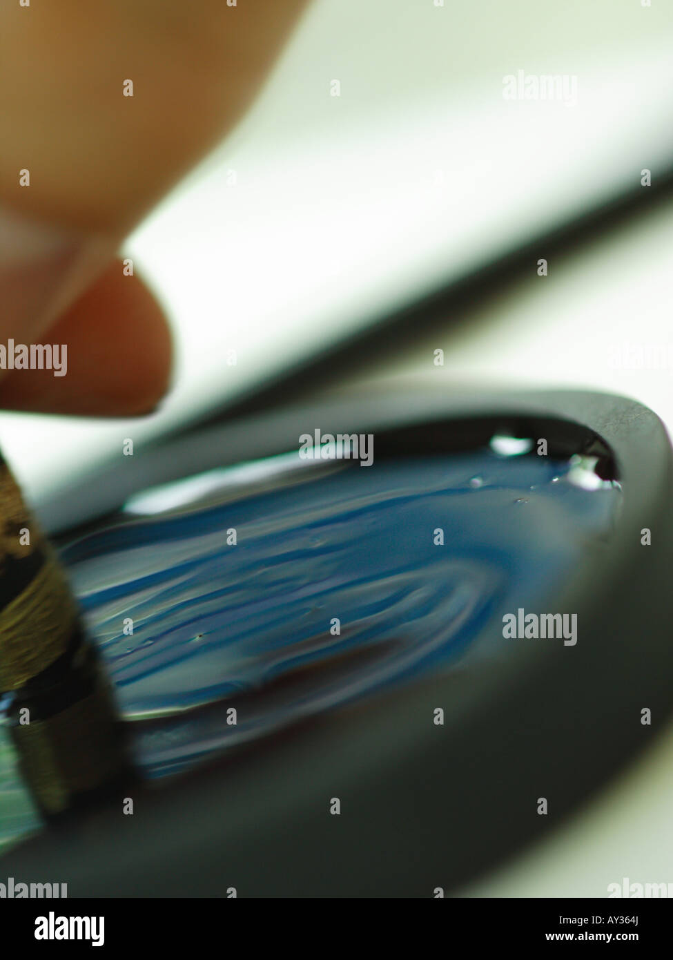 Close-up of a person's hand holding a ink stone Stock Photo