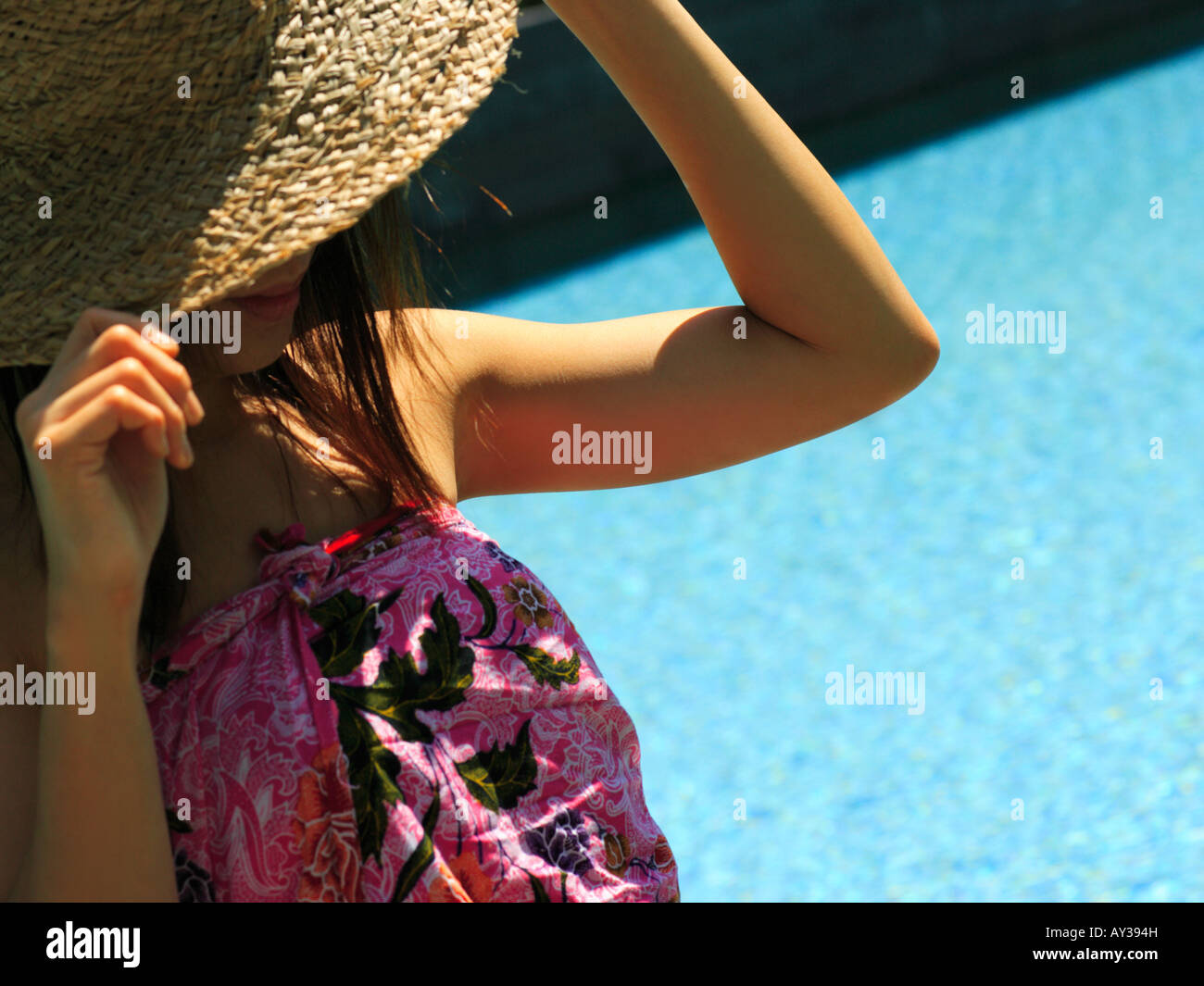 Woman adjusting straw hat hi-res stock photography and images - Alamy