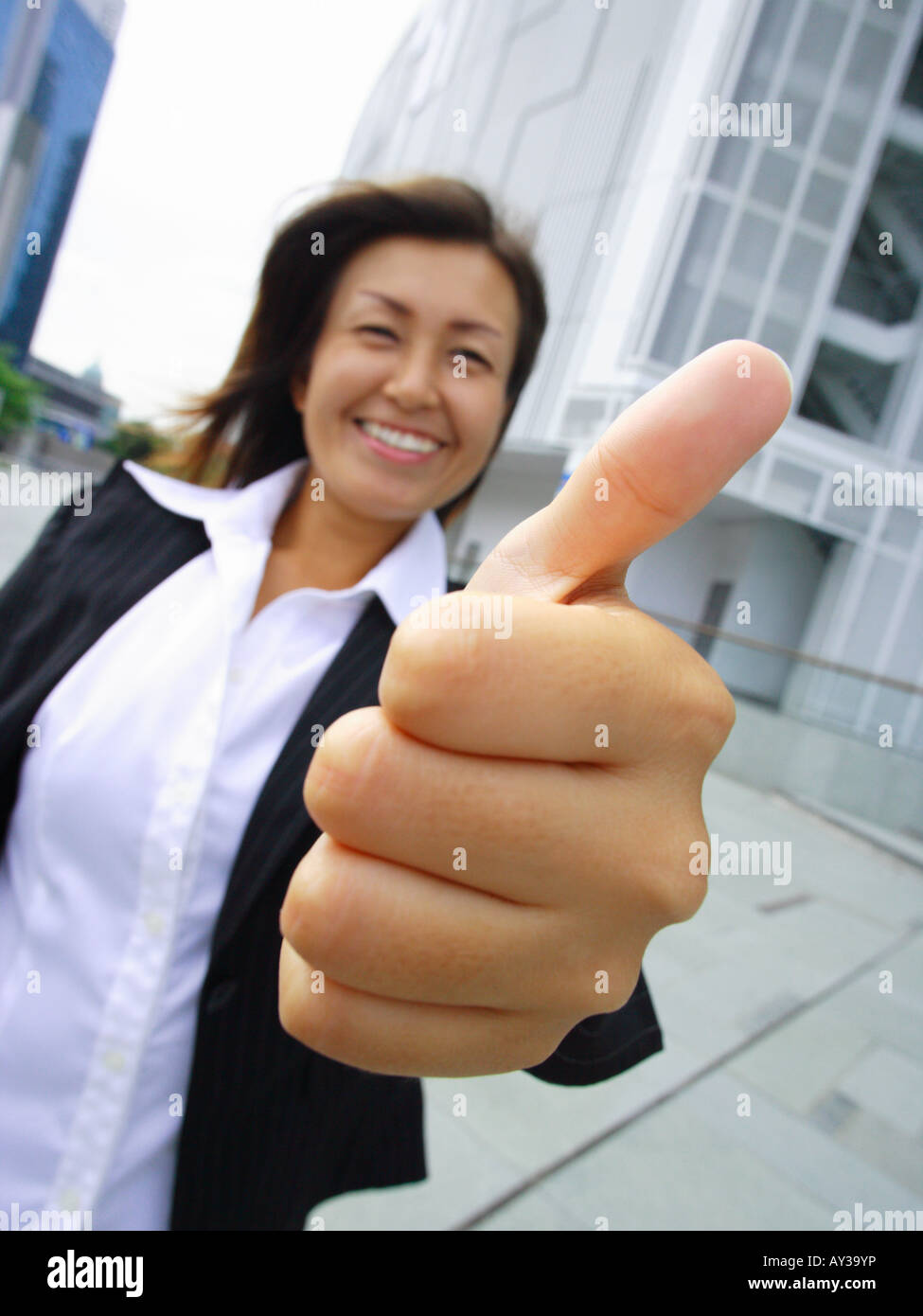 Portrait of a businesswoman showing thumbs up sign Stock Photo - Alamy