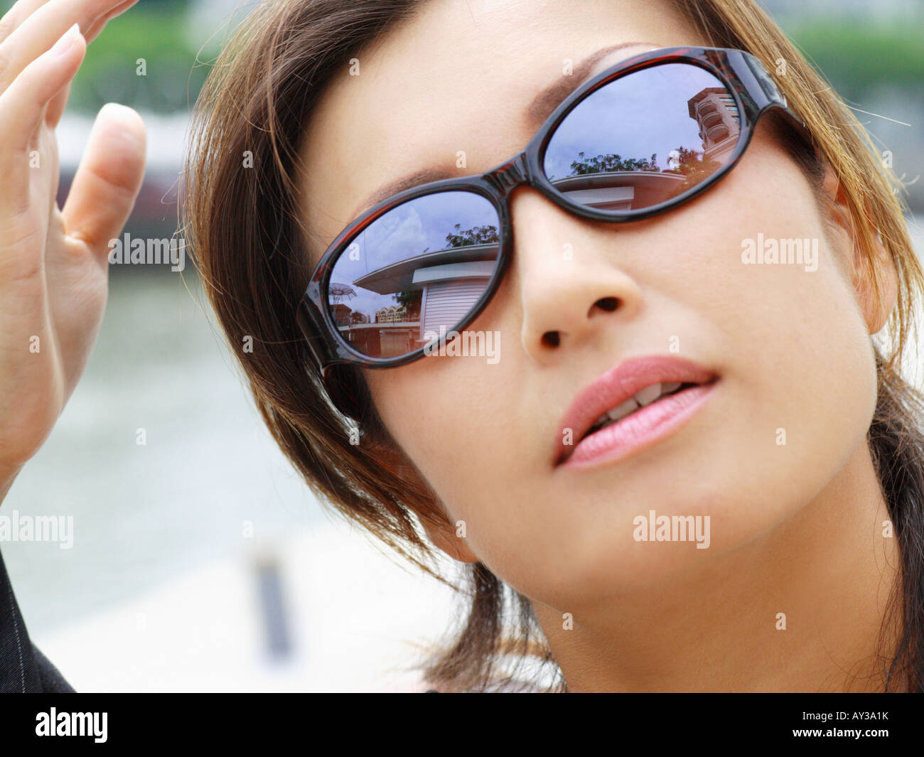 Close-up of a mid adult woman wearing sunglasses Stock Photo