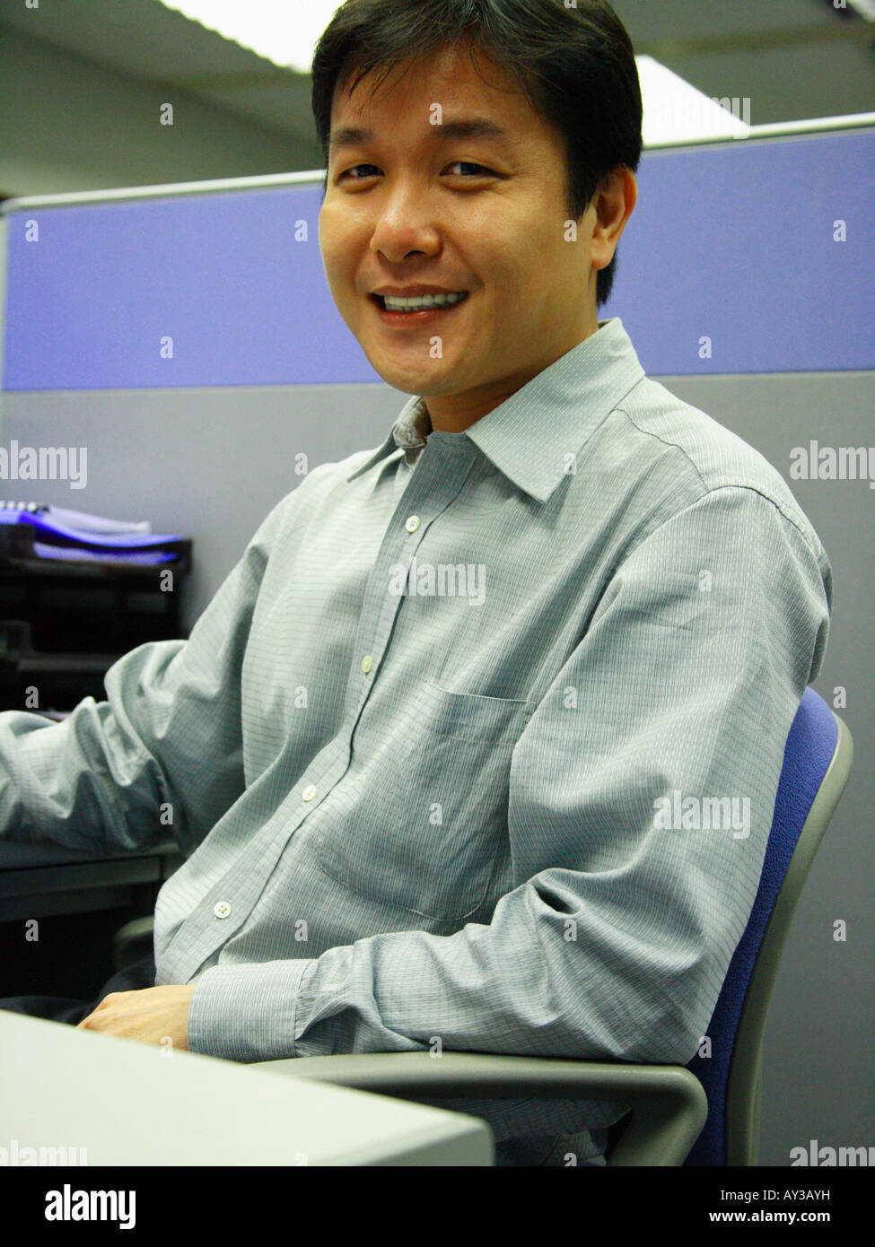Portrait of a businessman smiling in an office Stock Photo - Alamy