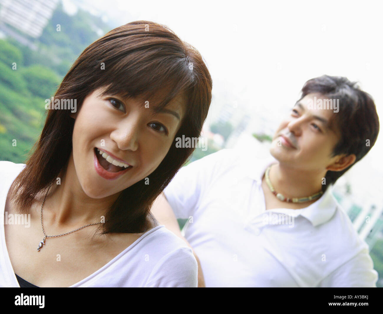 Portrait of a mid adult woman smiling with a mid adult man standing in ...